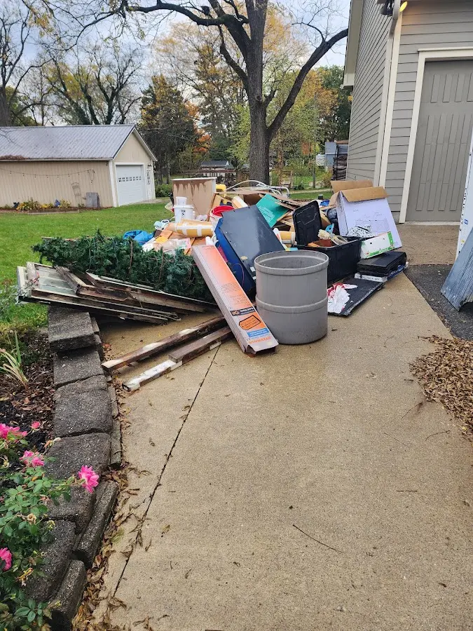 Dumpster being loaded with debris for 30 Yard Dumpster Rental in Sayre